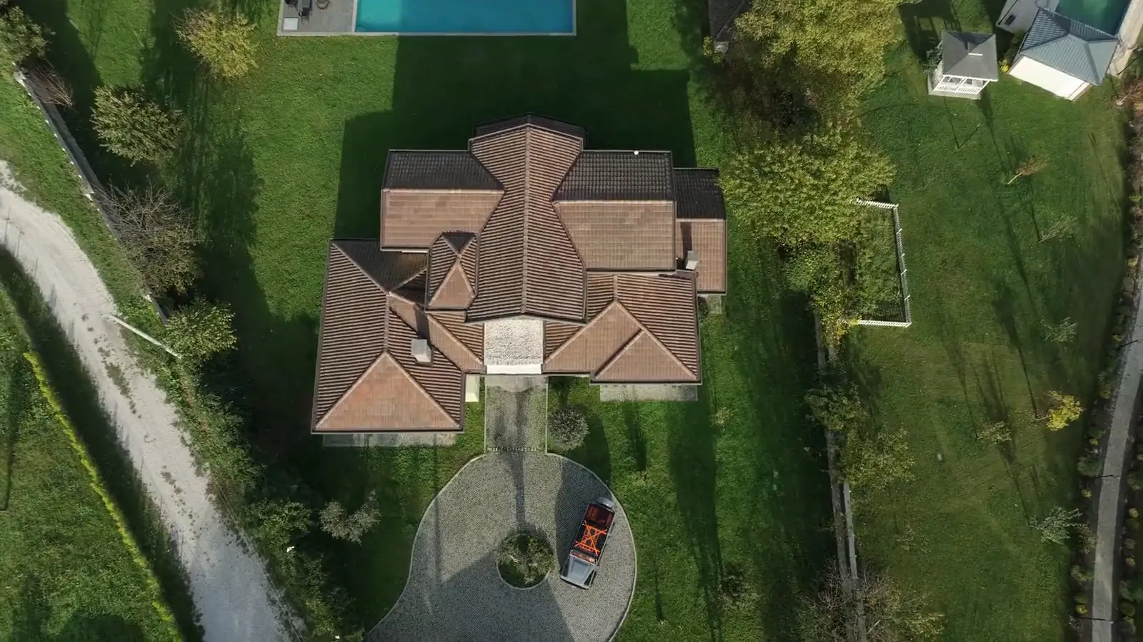 Grande casa con un ampio prato verde e la piscina, vista dall'alto
